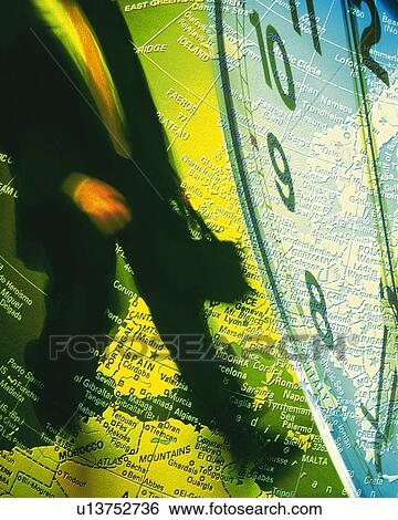Stock Photograph - Businessman with image of clock and globe, CG, composition, blurred motion. Fotosearch