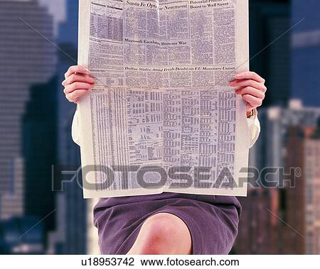 Stock Image - Businesswoman sitting and holding newspaper and image of buildings, front view, CG, composition. Fotosearch