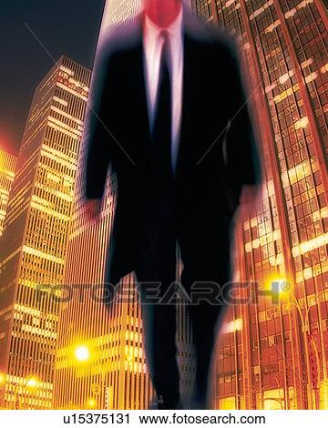 Stock Image - Businessman and building at the night, CG, composition, blurred motion, long exposure. Fotosearch