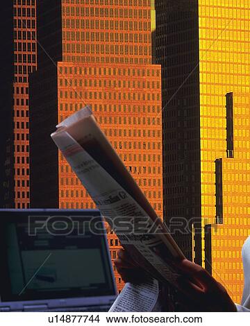 Picture - Businessman holding folded newspaper in office in New York City, NY, USA, CG, composition. Fotosearch