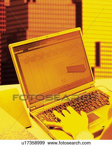 Stock Photo - Businessman using laptop in office in New York City, NY, USA, CG, composition, toned image. Fotosearch