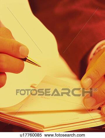 Businessman writing down and turning over personal organizer, toned image View Large Photo Image Stock Photography - Businessman writing down and turning over personal organizer, toned image. Fotosearch