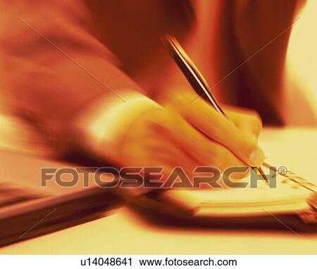 Stock Image - Businessman writing down on personal organizer, blurred motion, toned image. Fotosearch