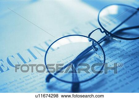 Glasses on newspaper, high angle view, close up, toned image View Large Photo Image Stock Photo - Glasses on newspaper, high angle view, close up, toned image. Fotosearch
