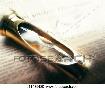 Hourglass on financial press, blurred motion, high angle view, close up View Large Photo Image Stock Image - Hourglass on financial press, blurred motion, high angle view, close up. Fotosearch