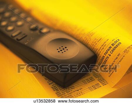 Phone receiver on telephone directory, high angle view, close up, soft focus View Large Photo Image Stock Photo - Phone receiver on telephone directory, high angle view, close up, soft focus. Fotosearch