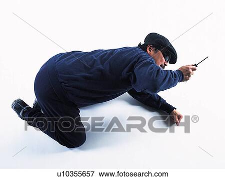 Stock Photo - Burglar breaking in, High Angle View. Fotosearch