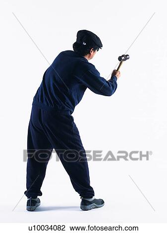 Stock Image - Burglar breaking in, Rear View. Fotosearch