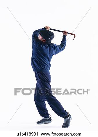 Stock Image - Burglar breaking in, Side View. Fotosearch