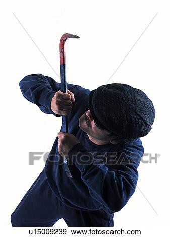Stock Photo - Burglar breaking in, Side View. Fotosearch