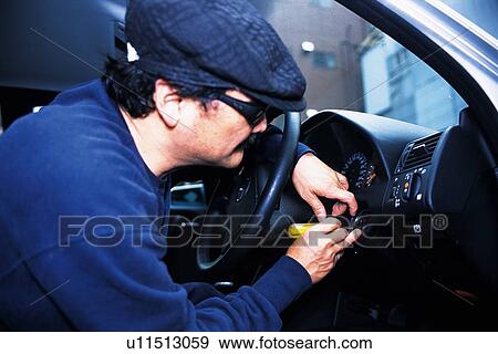 Burglar breaking into a car, Low Angle View View Large Photo Image Stock Photo - Burglar breaking into a car, Low Angle View. Fotosearch