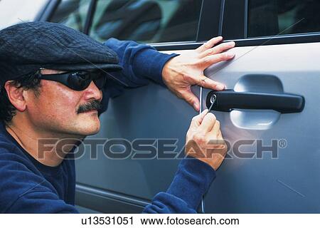 Burglar breaking into a car, Side View View Large Photo Image Stock Image - Burglar breaking into a car, Side View. Fotosearch