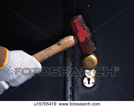 Hand breaking in with a hammer, Front View View Large Photo Image Stock Photo - Hand breaking in with a hammer, Front View. Fotosearch
