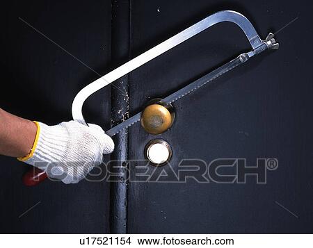Picture - Hand breaking in with a saw, Front View. Fotosearch