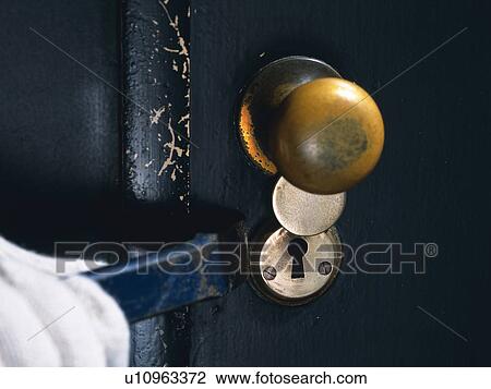 Stock Image - Hand breaking in with an iron bar, Close Up. Fotosearch