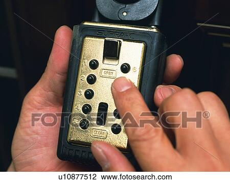 Hands unlocking the combination lock, Close Up View Large Photo Image Stock Image - Hands unlocking the combination lock, Close Up. Fotosearch