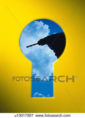 Stock Photo -  Key hole and a hand with a drill behind, Composite. Fotosearch