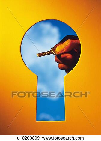 Stock Photo -  Key hole and a hand with a Key behind, Composite. Fotosearch