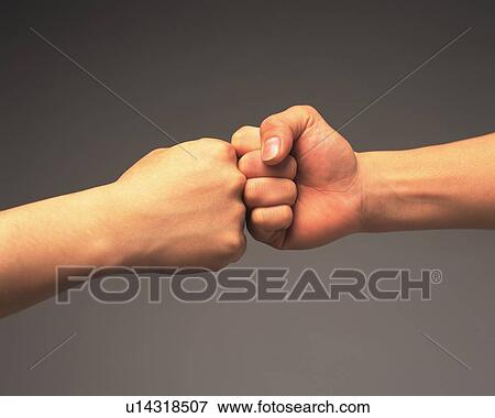 Fists of two people touching, side view View Large Photo Image Stock Photo - Fists of two people touching, side view. Fotosearch