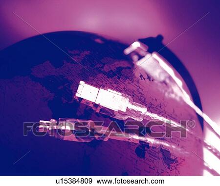 Stock Photo - Globe and computer cables, CG, composition, toned image, close up. Fotosearch