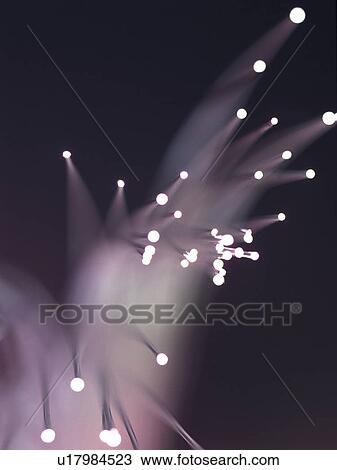 Stock Image - Glowing fiber optics, close up, blurred motion, long exposure. Fotosearch