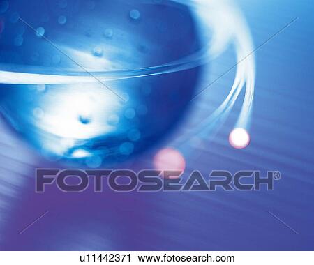 Stock Image - Illuminated ball of fiber optics, high angle view, close up, blurred motion. Fotosearch