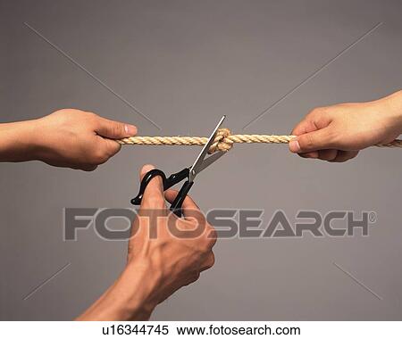 Man cutting a rope held by two people, high angle view View Large Photo Image Stock Photography - Man cutting a rope held by two people, high angle view. Fotosearch