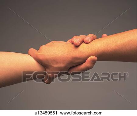 Two People Grasping Wrist Of Each Other Side View Stock Image U Fotosearch