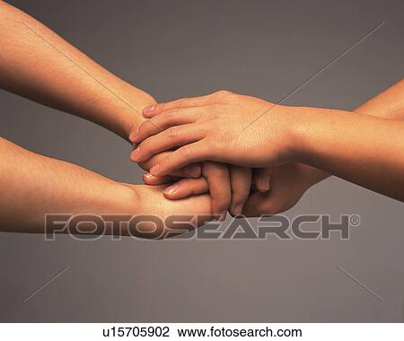 Two people piling hands, high angle view View Large Photo Image Stock Image - Two people piling hands, high angle view. Fotosearch