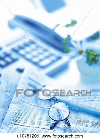 Stock Photography - Keyboard, Telephone, Newspaper, Glasses and Pen on the Desk, High Angle View, Blurred. Fotosearch