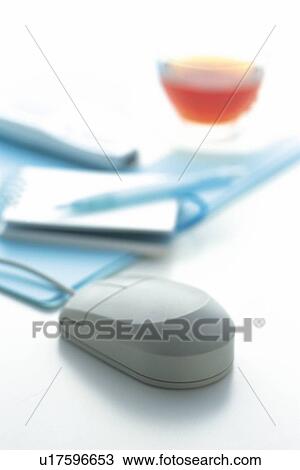 Stock Image - Mouse, Memo, Pen, Mobile Phone and Tea on the Desk, Close Up. Fotosearch