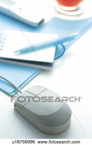 Stock Photograph - Mouse, Memo, Pen, Mobile Phone and Tea on the Desk, Close Up. Fotosearch