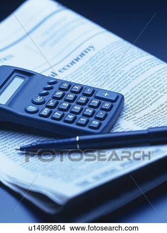 Picture - Calculator, pen and news paper, High Angle View, Toned Image. Fotosearch