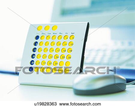 Stock Image - Calendar and mouse, Pin Focus. Fotosearch