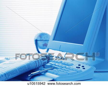 Stock Image - Computer and news paper, Toned Image. Fotosearch