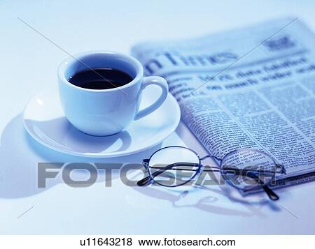 Stock Photo - Glasses, news paper and cup of tea, High Angle View, Toned Image. Fotosearch