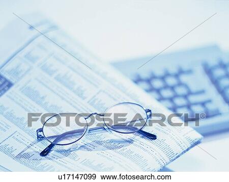 Stock Photo - Glasses, news paper and keyboard, High Angle View, Toned Image, Pin Focus. Fotosearch