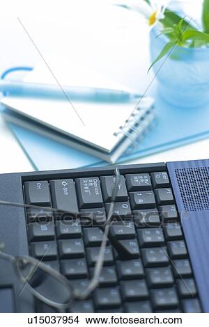 Glasses on a laptop computer, Pin Focus, High Angle View View Large Photo Image Picture - Glasses on a laptop computer, Pin Focus, High Angle View. Fotosearch