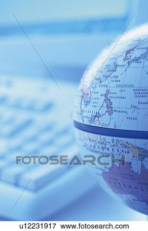 Stock Photo - Globe and computer, Close Up, Pin Focus. Fotosearch