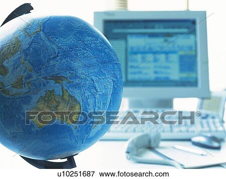 Stock Photo - Globe and computer, Pin Focus, Toned Image. Fotosearch