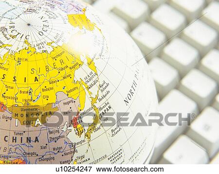 Stock Photo - Globe and keyboard, Close Up, High Angle View. Fotosearch
