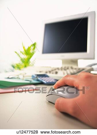 Stock Photo - Hand using mouse, Pin Focus, Low Angle View. Fotosearch