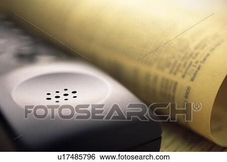 Stock Photograph - Handset and news paper, Close Up, Pin Focus. Fotosearch