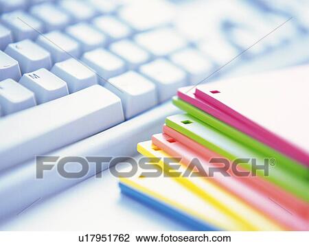 Stock Image - Keyboard and Colorful discs, Close Up, High Angle View. Fotosearch