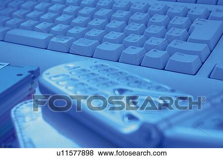 Stock Photo - Mobile phone and keyboard, Pin Focus, Toned Image. Fotosearch