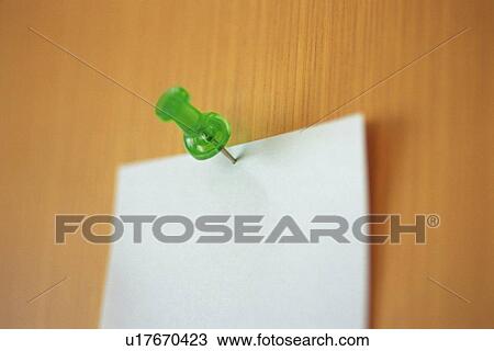 Stock Image - Note put on a wall with a tack, Pin Focus, Close Up. Fotosearch