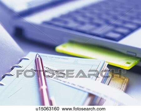 Stock Image - Scheduler and laptop Computer, Pin Focus, High Angle View. Fotosearch