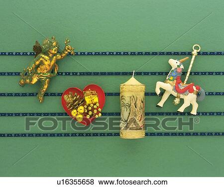 Christmas ornaments on blue lines, green background, high angle view View Large Photo Image Stock Photo - Christmas ornaments on blue lines, green background, high angle view. Fotosearch
