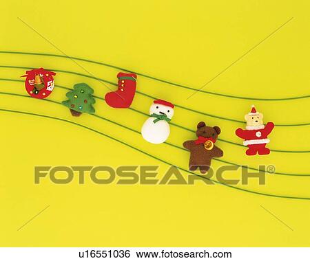 Christmas ornaments on lines, yellow background, high angle view View Large Photo Image Stock Photograph - Christmas ornaments on lines, yellow background, high angle view. Fotosearch