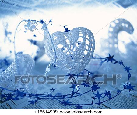 Stock Photo - Christmas ornaments on newspaper, close up. Fotosearch